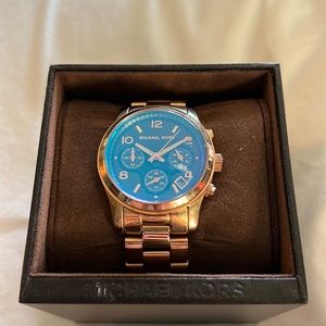 Michael Kors watch. Gold band with brown and iridescent face